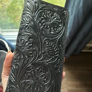 Black tooled leather and dark hide wallet