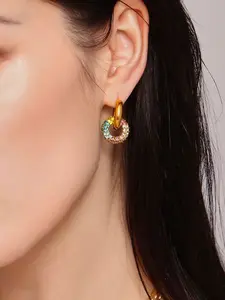 A pair of fashionable double ring cross gold-plated earrings with a retro light luxury design featuring a gold ring and a zirconia ring, suitable for commuting, dating, or light formal occasions.