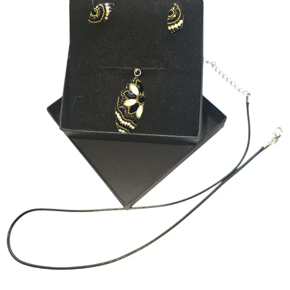 Rubylishious  Silver set of earrings and pendant almond shape black, gold white pendant  .925 silver  Made in Mexico  Comes with a Sterling Silver Satin Rat Tail Cord 2oz