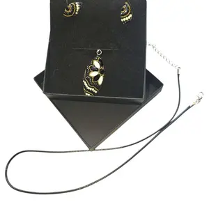 Rubylishious  Silver set of earrings and pendant almond shape black, gold white pendant  .925 silver  Made in Mexico  Comes with a Sterling Silver Satin Rat Tail Cord 2oz