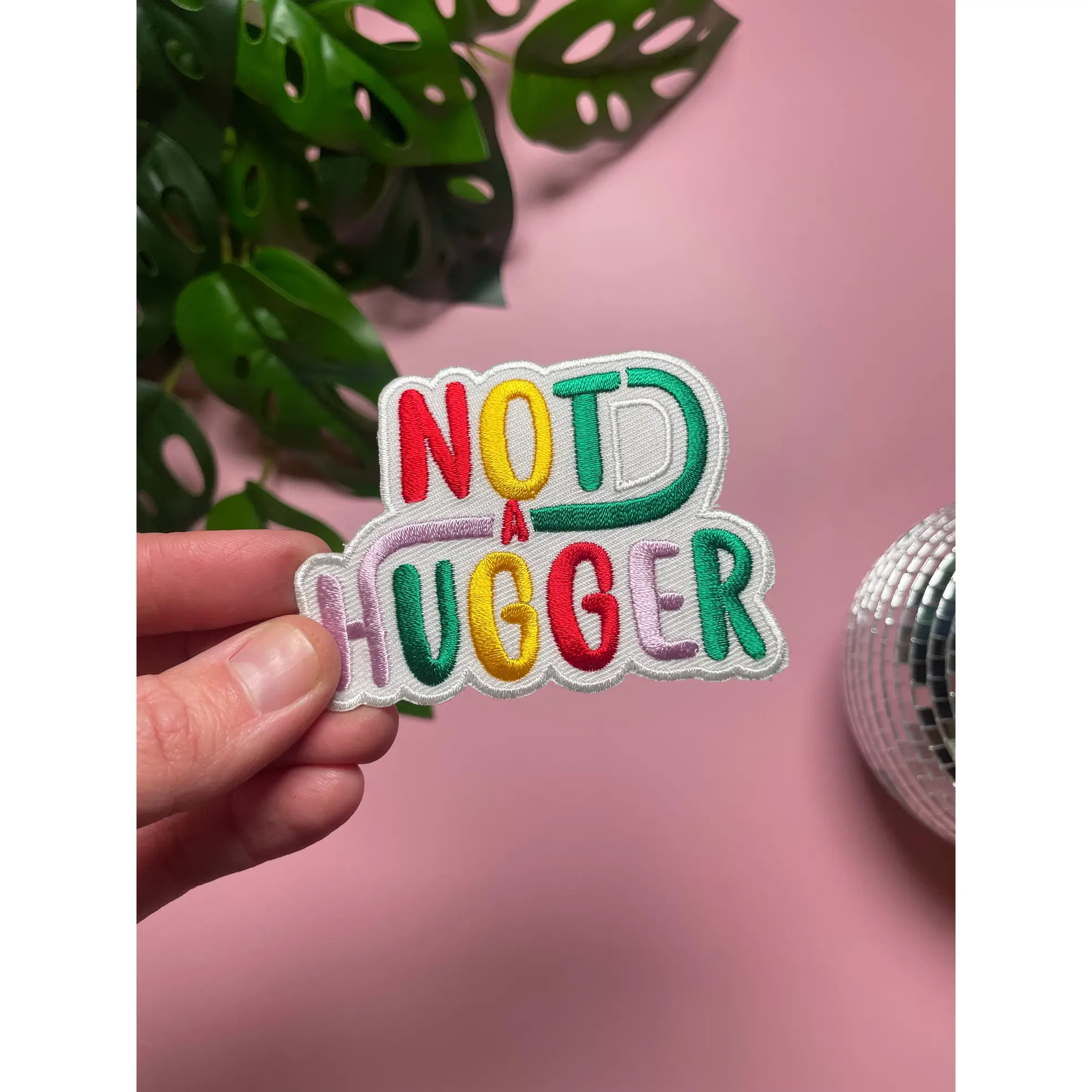 Not a Hugger 4 inch iron on patch, designed by latenightcrew AU.