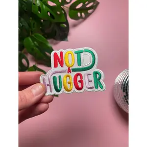 Not a Hugger 4 inch iron on patch, designed by latenightcrew AU.