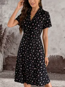 A women's dress with a black base and pink floral pattern, featuring a notched collar, short sleeves, a cinched waist, and an A-line mid-length cut, the style is vintage, Casual Wear, practical for work