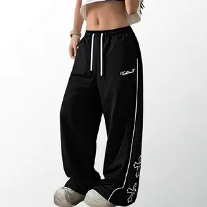 Women’s lightweight athletic pants with a soft, loose fit; gray long pants with a cross print on the side; comfortable, casual sports bottoms for the gym; unisex design.