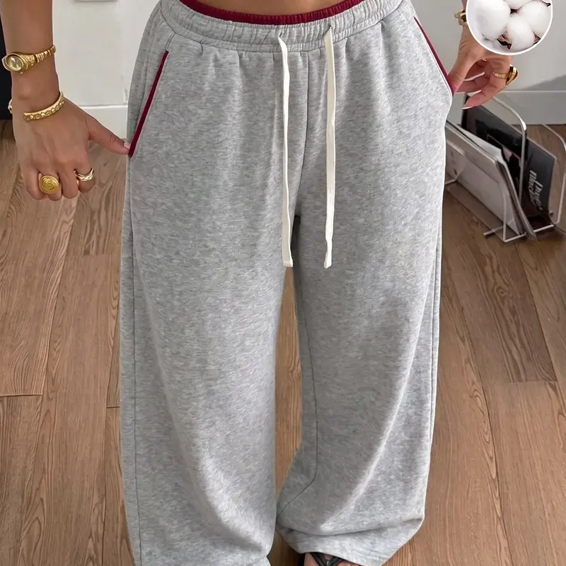 Women’s 50% cotton wide-leg sweatpants with contrast piping, elastic waistband with drawstring, pockets, and a loose fit—soft and comfortable, suitable for home wear, running errands, and everyday streetwear.