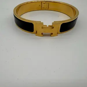 Pre-owned Hermes Clic H Gold / Black bracelet