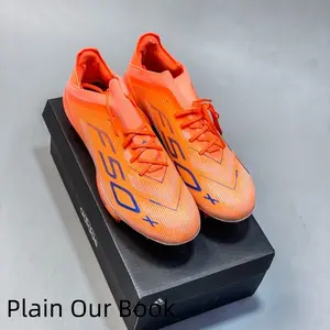 Comfortable and versatile orange synthetic turf soccer shoes