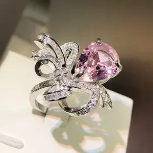 Epic Pink Pear in a Bow Adjustable Ring with Sparkling Accents and Elegant Design