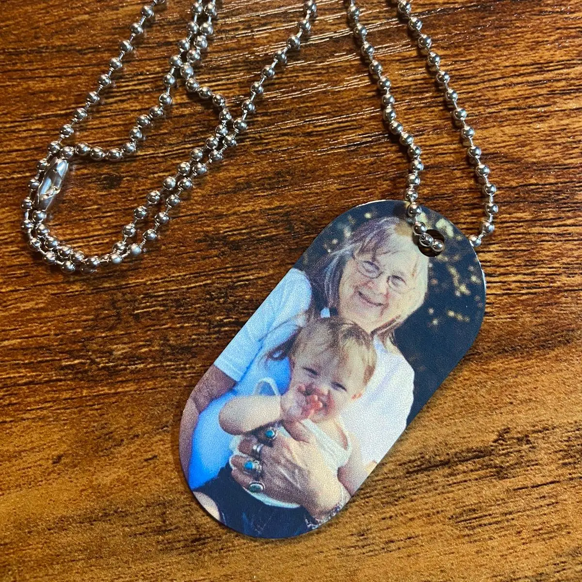 Personalized metal dog tags with bead chain.