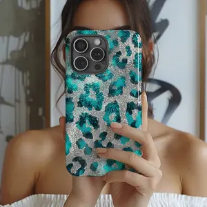 This durable, shock-absorbing, glossy 2-in-1 phone case features a turquoise and silver leopard print design. It's compatible with iPhone 17, 16, 15, 14, 13, 12, 11, X, and Samsung models, making it a perfect holiday gift for friends or family.