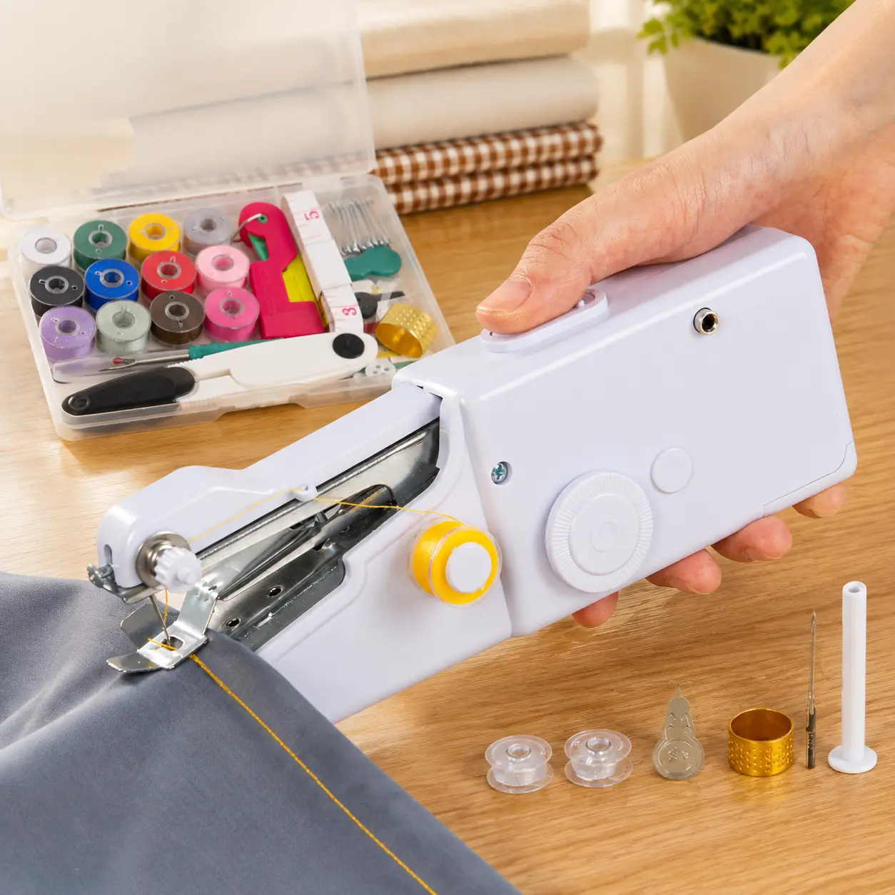 White mini handheld electric sewing machine, equipped with a complete sewing accessory set, stored in a storage box, portable mini sewing tool, suitable for clothing repair, beginner DIY and emergency fabric restoration.