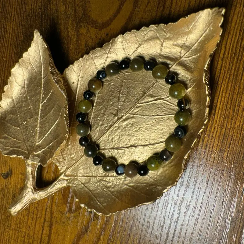 Swamp Monster Bracelet - Simple Design with Black and Green Beads on a Leaf Background