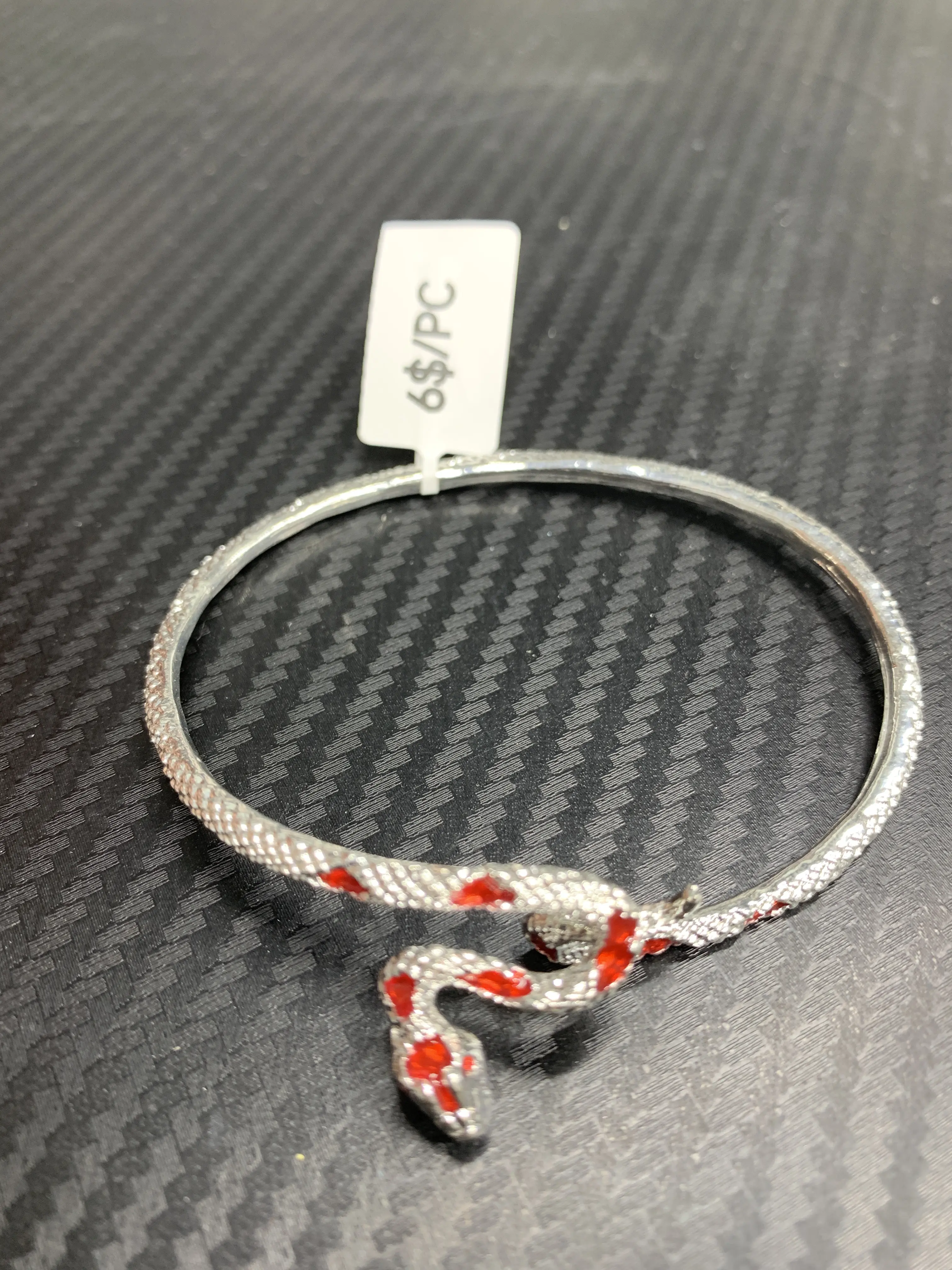 Candice(13048)gc.This silver snake bracelet is elegantly  with sparkling , wrapping gracefully around the wrist. Its sleek, coiled design exudes mystery and sophistication, making it a stunning statement piece that blends boldness with refined beauty.