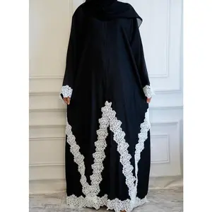 Rania Lace Abaya is a 2 piece set featuring a black open-front design with buttons to style open or closed. Finished with white lace on the hem, sleeves, and side of the hijab. Perfect for Eid or any special occasion