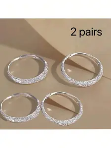 Two pairs of earrings: sparkling star-patterned hoop earrings and matte sparkling hoop earrings. Perfect for Valentine's Day and Mother's Day jewelry gifts. Women's jewelry, earrings, hoop earrings, and drop earrings. Stylish for both everyday wear and as