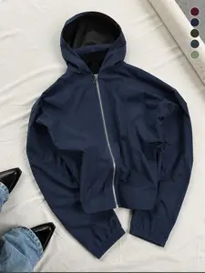 Men’s all-season loose navy hooded jacket featuring a cropped, relaxed hem and hidden storage side pockets, wrinkle-resistant fabric, metal zipper, and ribbed cuffs—suitable for streetwear, office commuting, and short hikes.
