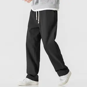 A pair of men's wide leg casual pants, featuring a stylish casual design with an adjustable drawstring at the waist for added comfort. The corduroy fabric is of good quality, with clear vertical stripe texture, showcasing a unique fashion taste. The wide