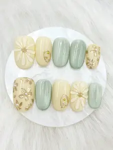 10pcs handmade short oval press on nails in yellow and green cat eye finish, Y2K style with hand-painted gold lines and 3D water drop flowers, fresh and luxurious full cover artificial nails for daily wear and holiday gifts