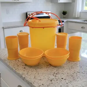 Set of water container, plates and glasses in orange.