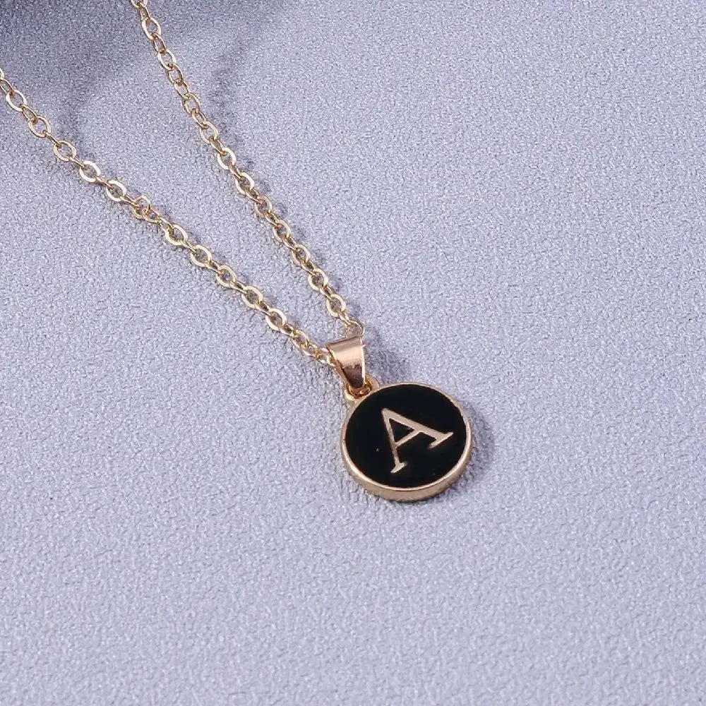 Stainless steel initials. Available in white or black with a 20-inch stainless steel chain.