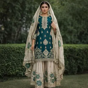 Indian ensemble featuring a teal embroidered kameez (tunic), cream-colored gharara pants, and a matching embroidered dupatta (scarf). This specific style is a sharara or gharara suit, characterized by wide-legged flared pants and an intricately embellish