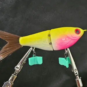5 Inch Glide Bait with Brush Tail and VMC Treble Hooks. Thie glide is slow sinking, just under 5 inches from noes to the tip of the tail and weighs 1/2 OZ.