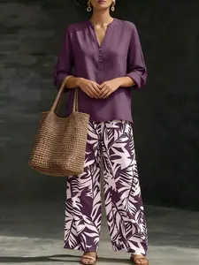 Women’s fashion casual two-piece set featuring a V-neck top with design details paired with wide-leg pants with a botanical pattern; comfortable and breathable, suitable for multiple occasions.