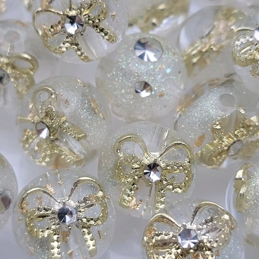 15.5mm Resin bead with bow, rhinestones and gold flakes with glitter