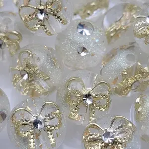 15.5mm Resin bead with bow, rhinestones and gold flakes with glitter