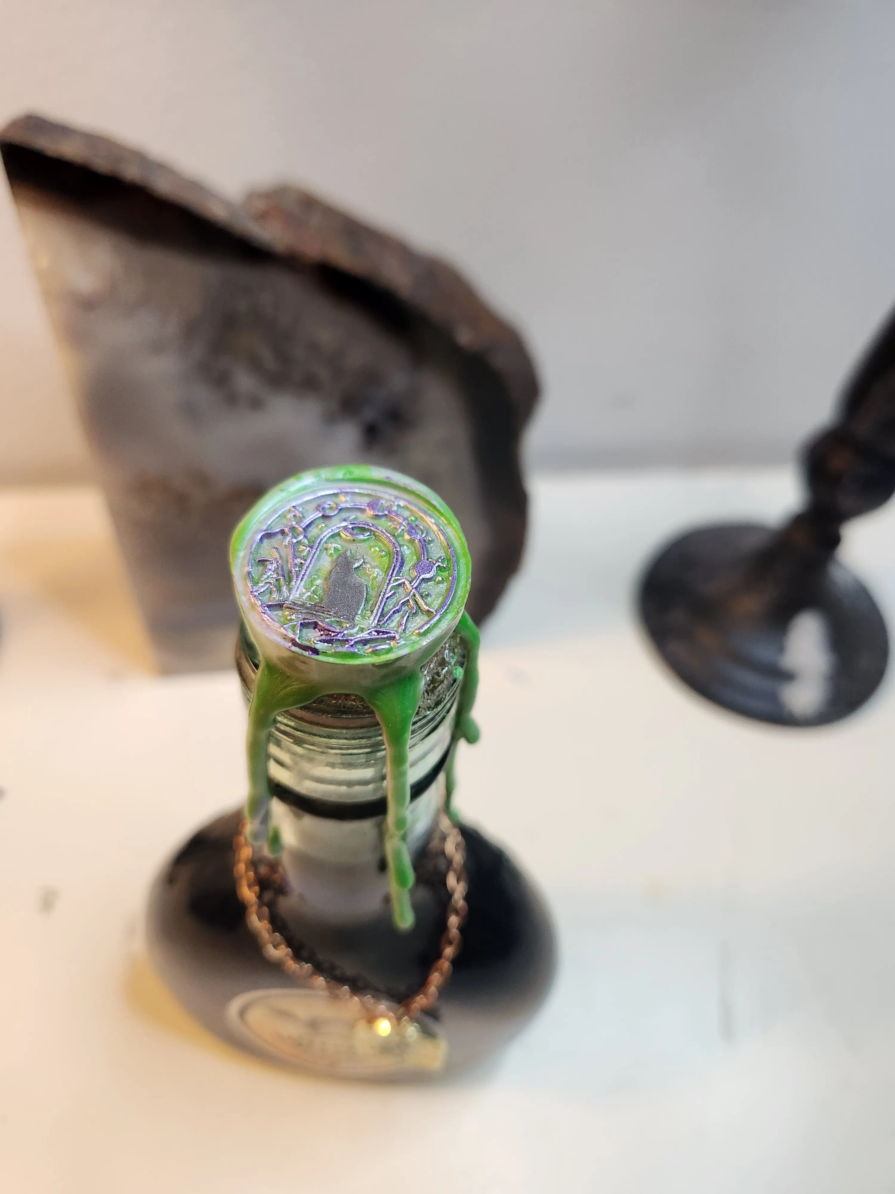 Thicket Hill Games, Witches Brew Potion Bottle, Perfect as a Halloween Decoration or gift, liquid is made from colored water and mica powder, each variation features a witchy charm, authentic antique bottle and a cat-familiar wax seal. Spooky