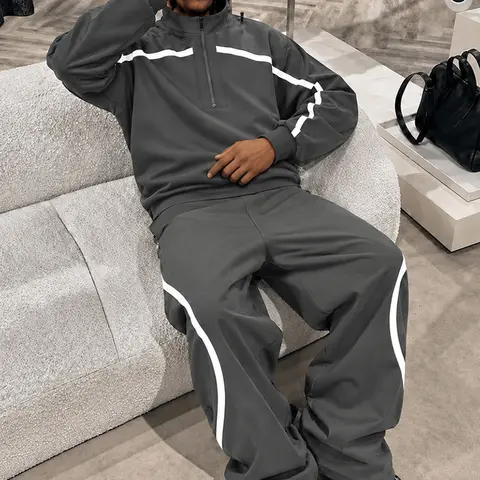 Men’s dark gray two-piece athletic set — high-neck ribbed sweatshirt and wide-leg striped pants, featuring a white color-block design; breathable American vintage street-style casual outfit.
