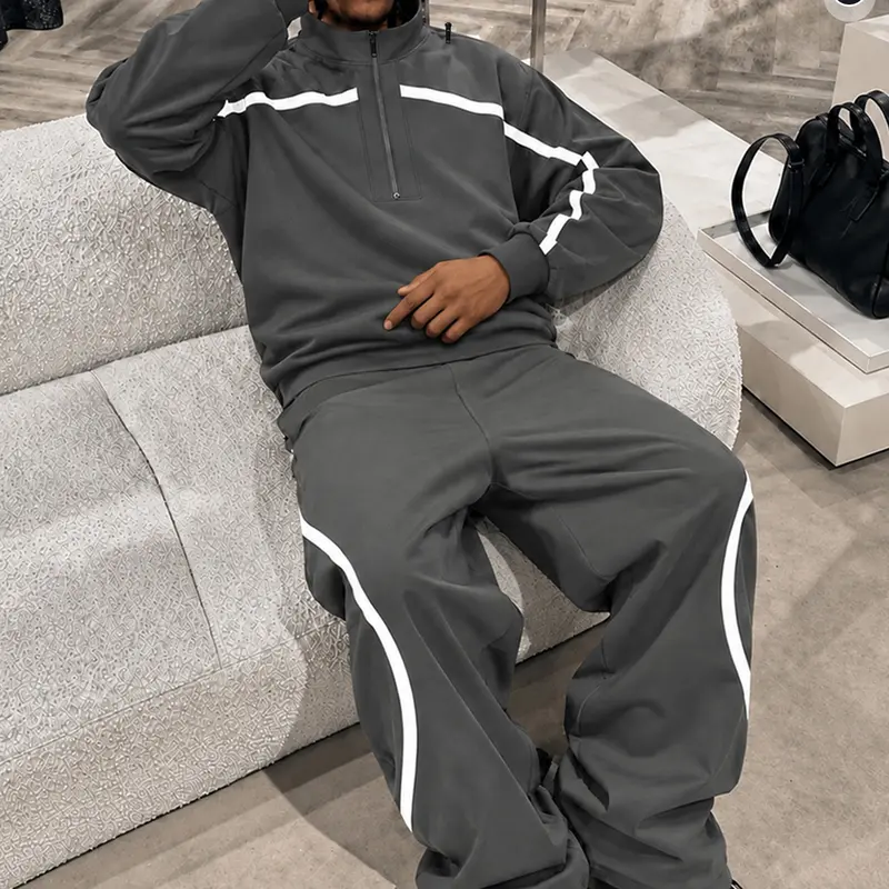 Men’s dark gray two-piece athletic set — high-neck ribbed sweatshirt and wide-leg striped pants, featuring a white color-block design; breathable American vintage street-style casual outfit.