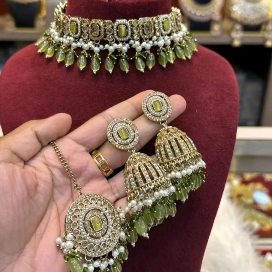 Premium Reverse AD Antique Gold Choker Set with Jhumka and Tikka Featuring Gemstones and Pearl Accents for Elegant Looks