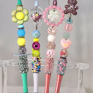Set of 4 Fancy Bead, Fidget, beaded pens, with extension rods. 1 flower fidget pen, 1 candy shaker fidget pen, 1 flower fidget pen, 1 fancy rhinestone teddy bear with perfume bottle.