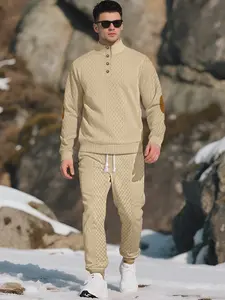 Men's knitted suit. The top features a half-placket and a high neckline, paired with simple and practical buttons. The brown elbow patches create a color contrast and match the drawstring jogger pants in the same color family. The fabric is thick.