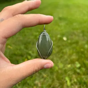 Green stone wrapped with silver wire