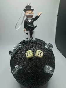 Mr. Monopoly with pewter game pieces, dice and money on 6" black sphere