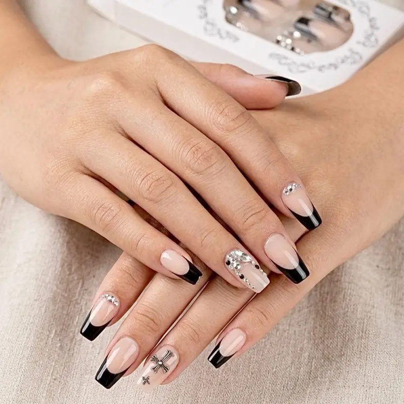 Elegant Black and Nude Nail Art Set with Rhinestones and Cross Design for Stylish Manicure