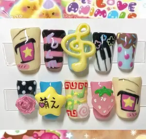 kawaii decora style press on nails with 3d designs featuring star, music note, piano keys, strawberry, candy, flower and pastel patterns for a cute jpop vibe