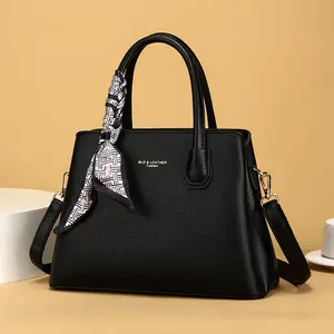 Luxurious black structured genuine leather new fashion handbag, versatile carry options—perfect for commuting, everyday office use, casual outings, and parties, paired with an elegant silk scarf accent.