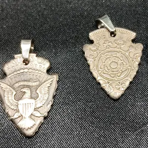 hand cut Kennedy 50 cent piece in the shape of a arrowhead