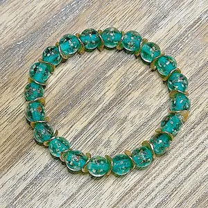 Lake blue firefly 8mm beaded bracelet with gold filled wavy spacer beads