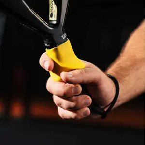 Two tennis racket handle correctors. Designed to prevent beginners from gripping the racket too tightly. Fixed devices for maintaining the correct grip posture for both the forehand and backhand in tennis. Training auxiliary equipment.