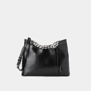 Oiled leather textured clutch bag with thick metal chain strap. Oiled leather textured clutch bag with thick metal chain strap.