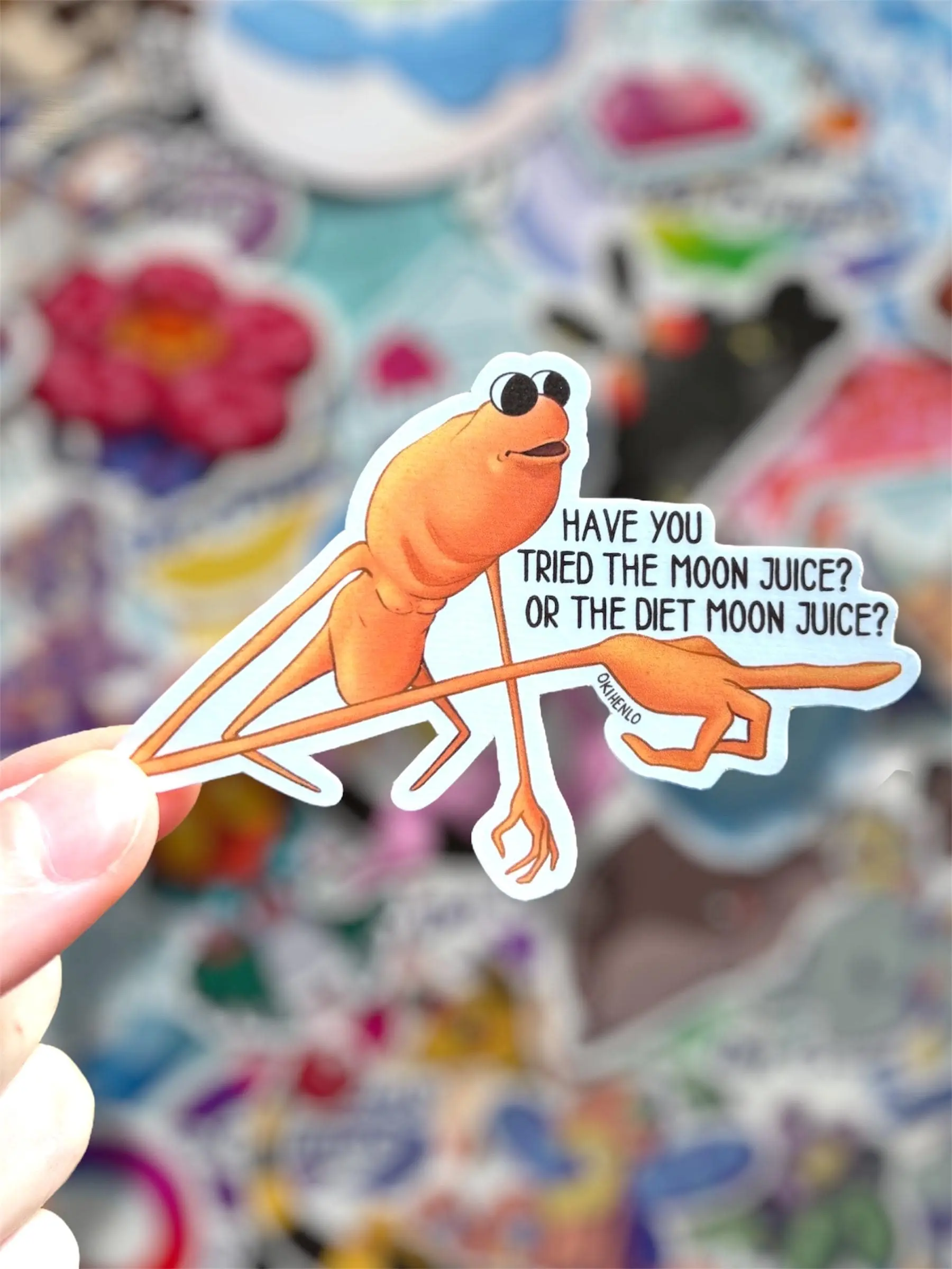 Marcus VRChat Worm Vinyl Sticker - 2x2in Collectible for VRChat Worm Fans, 1-Side Printed, Features "Have You Tried the Moon Juice?" Design to Decorate Surfaces, 2X2inch