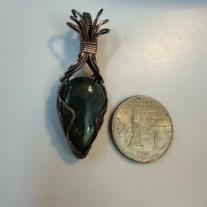 Labradorite stone wrapped in oxidized copper wire