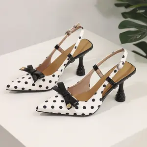Women's black-and-white polka dot pointed-toe open-back high-heel sandals with adjustable buckle ankle straps and slender stiletto heels