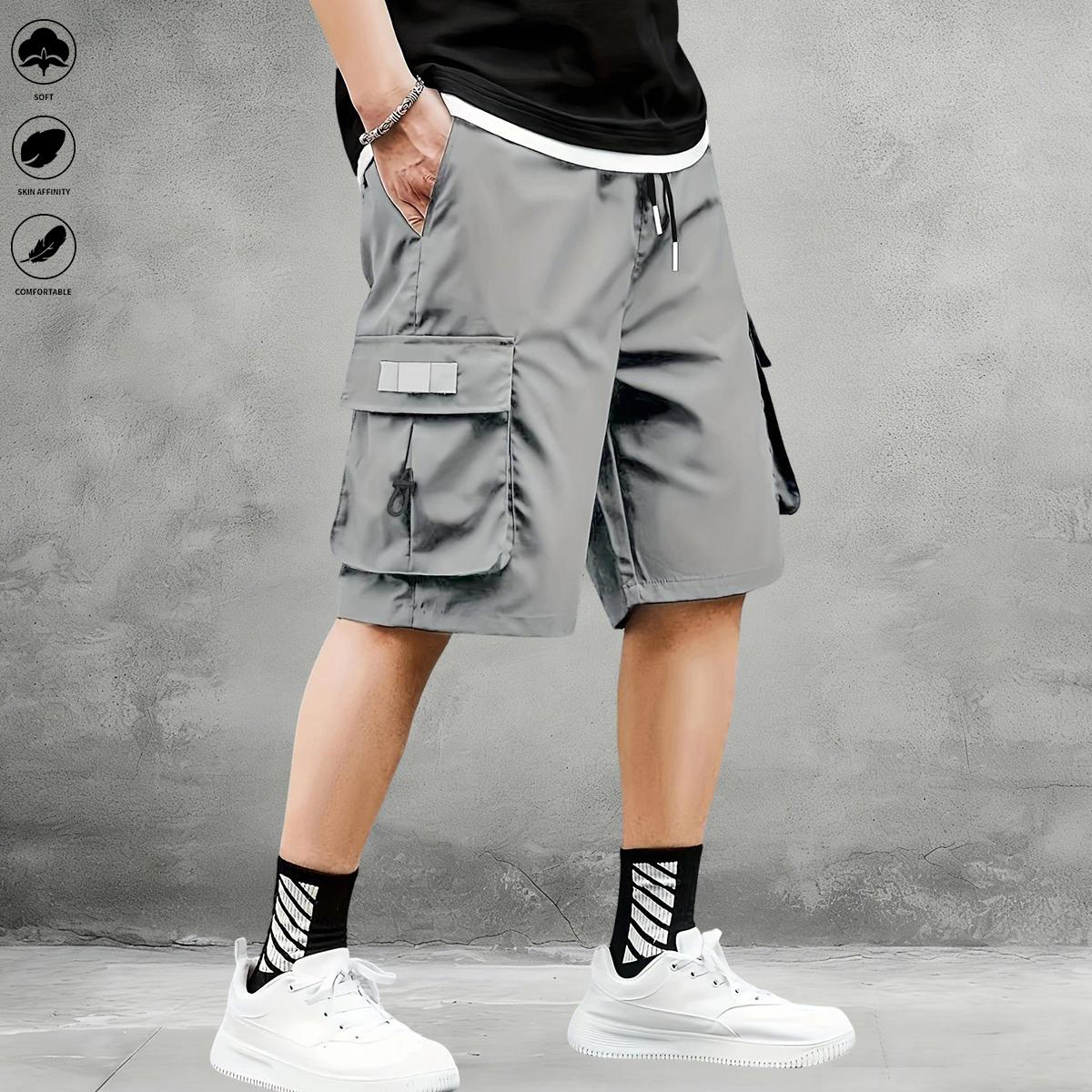 New summer men’s tactical cargo shorts with multiple pockets, made from breathable, quick-dry fabric with slight stretch; suitable for casual outings and travel; elastic drawstring waist for relaxed wear.