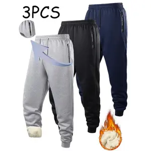 Men's fleece-lined joggers with an elastic waistband and zippered pockets - thick winter warm-up pants suitable for outdoor runs and everyday casual wear. Pack of three.