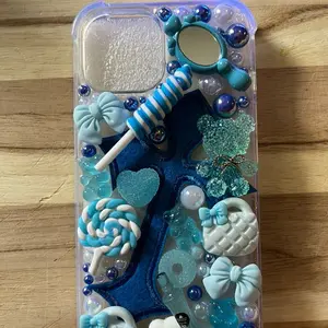 Blue iPhone 15 Junk Case with Decorative Elements, Includes Colorful Accents and Fun Accessories
